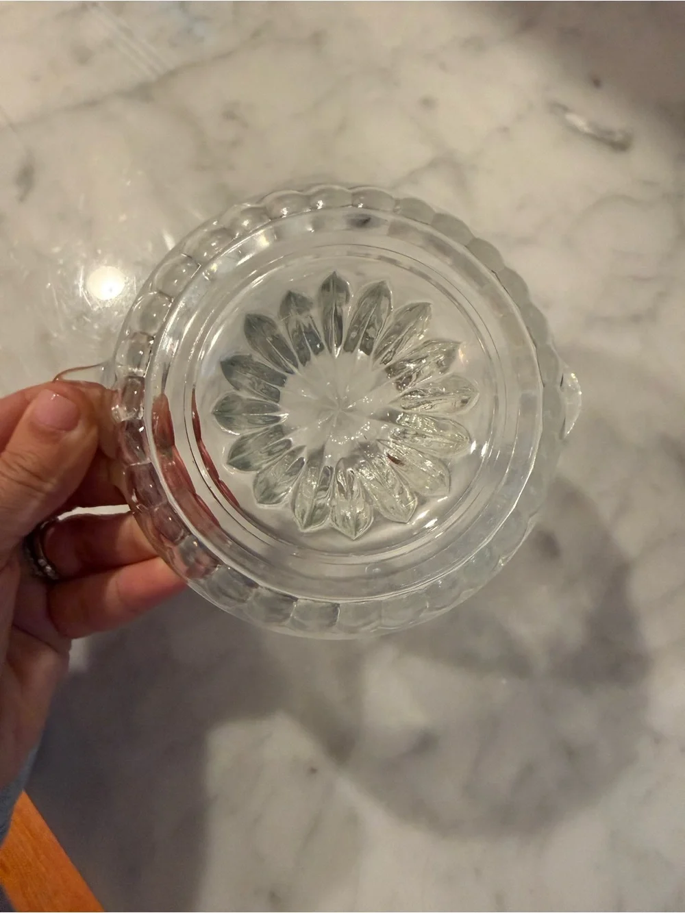vintage clear glass manual citrus orange juicer with a ribbed reamer and handle